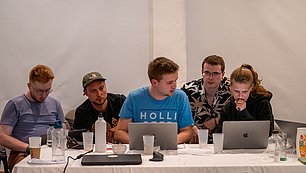 People in front of their laptops.
